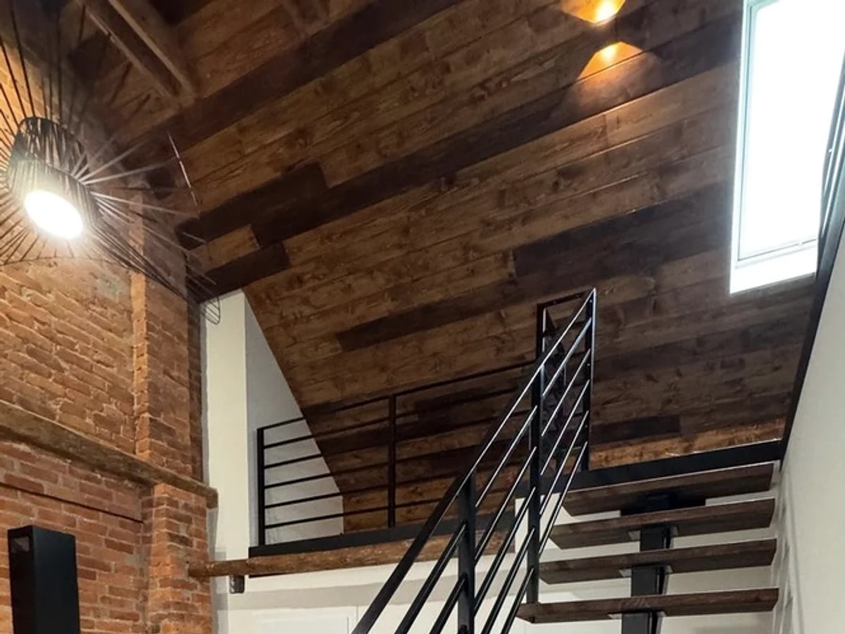 Steel structure next to brick and timber.